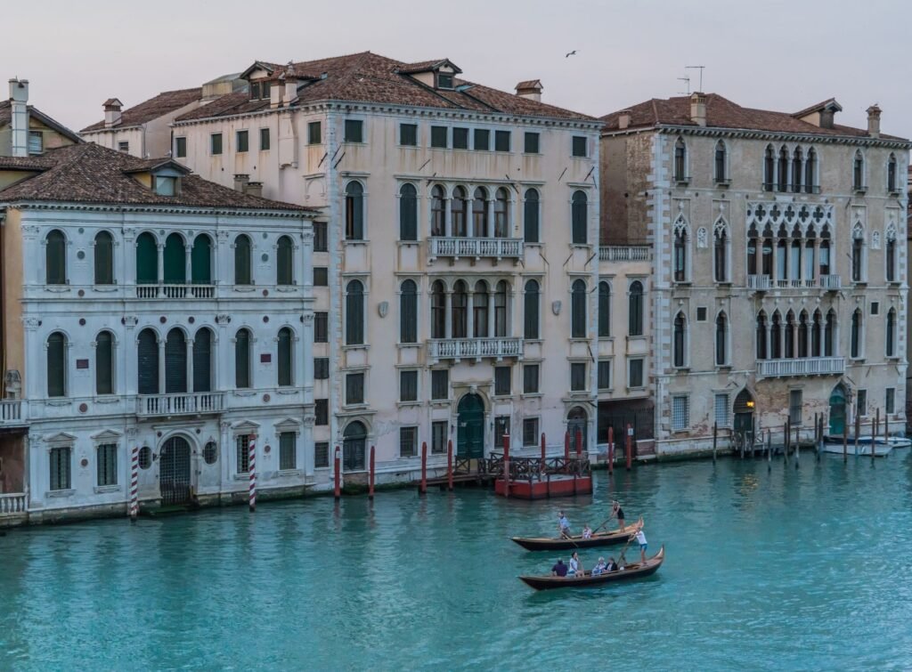 Elegant Venetian buildings and gondolas on a canal at dusk, Venice, Italy