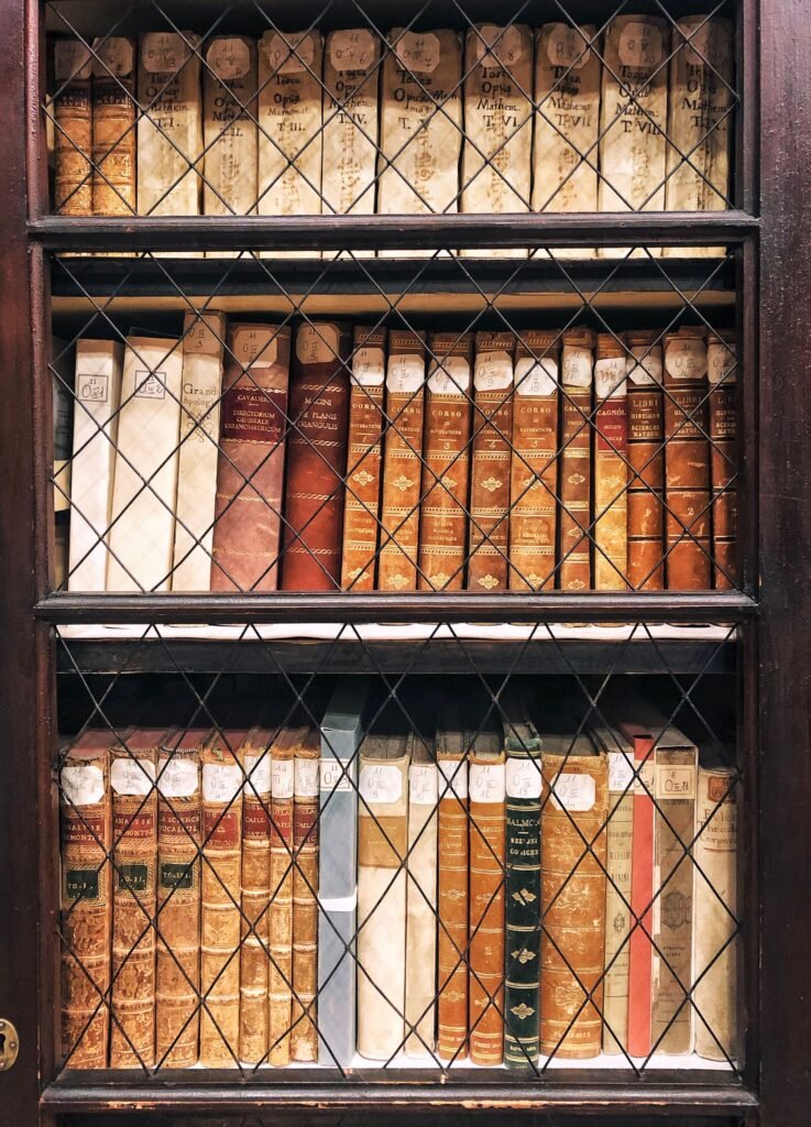 Vintage bookshelf in a historic Italian library, representing the What is New In Italy 40-year archive